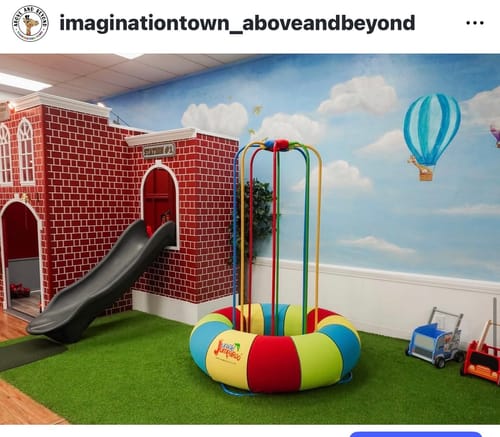 Customer's colorful Jungle Jumparoo set up in a large indoor play area on artificial grass.