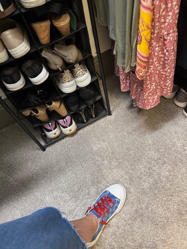 Customer wearing the Very G Dark Denim Aman Usa Sneaker with bright red laces in a closet.