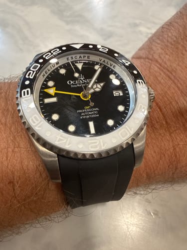 Reviewer's wrist shot of an Oceaneva watch fitted with a black rubber strap.