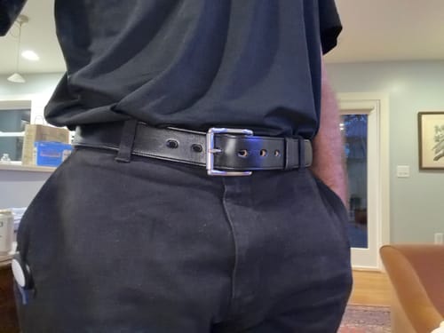 Reviewer showing the good fit of their black Canyon belt worn with black pants and a black shirt.
