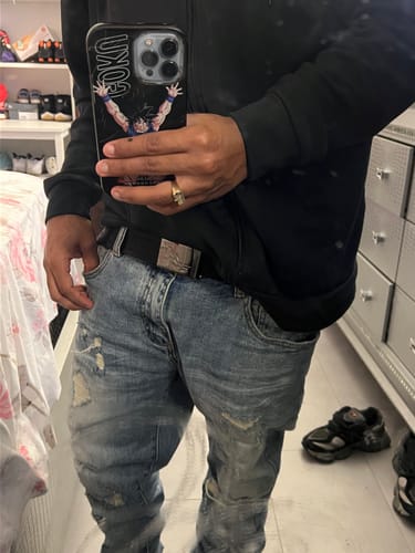 Reviewer wearing the black ISWT JACQUARD BELT with light-wash distressed jeans.