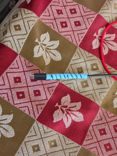 Customer shows a light blue spiral Cable Protector wrapped around the end of a black cable.