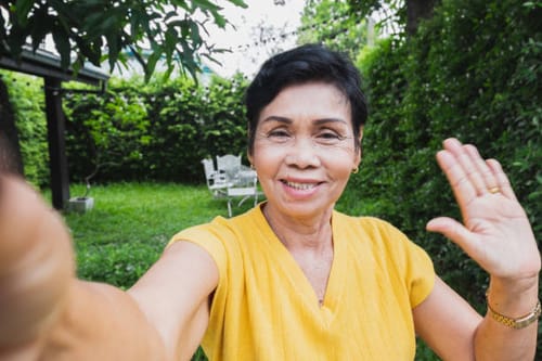 Reviewer smiling while taking a selfie outdoors, happy with the results of their Qi Coil™ Max Transformation System.