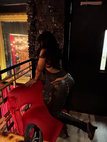 Reviewer from behind wearing the black Vice Pant, showing studded and lace-up details.