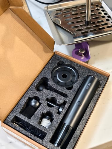 Customer's Barista Air Wand and its various cleaning attachments laid out in the open product box.