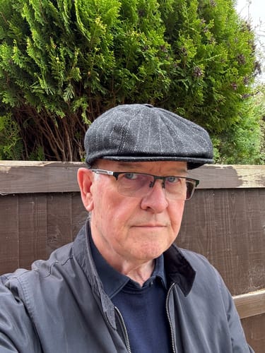 Reviewer wearing the charcoal pinstripe Shelby Baker Boy Connery Cap outdoors.