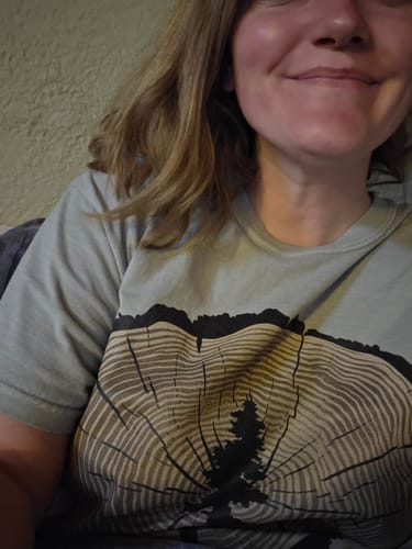 Close-up of a reviewer wearing the Stump Of Life T-shirt, showing the large tree ring graphic.