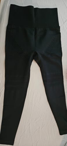 Customer's black Silix leggings laid flat, showing the high-waisted front and textured thigh details.