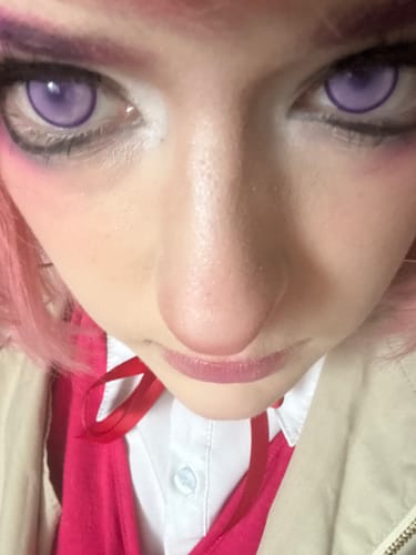 Close-up of a reviewer in cosplay wearing the bright Cosplay Fairy Purple Colored Contact Lenses.