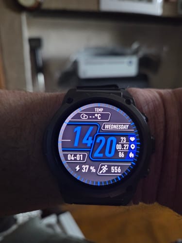Close-up of a reviewer's Gard Pro Ultra 3 on their wrist, showing the detailed digital watch face with time and battery percentage.