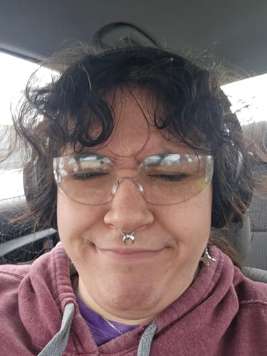 Reviewer smiling in a close-up shot, wearing the silver REAL LUNA SEPTUM.