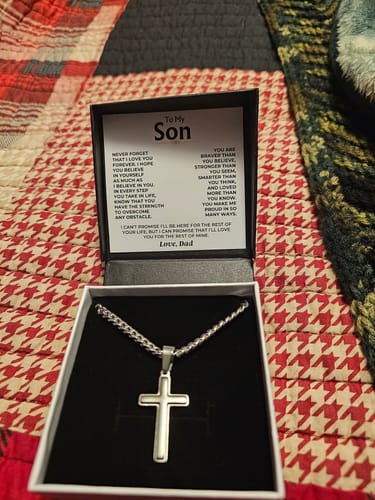 Customer's open gift box showing the artisan cross necklace and the 'To My Son' message card from Dad.