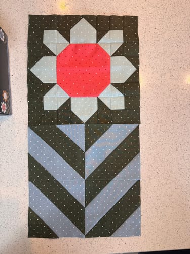 Customer's sewn flower and stem block from the Spring Fling Quilt Kit, showing the colorful polka-dot fabrics.