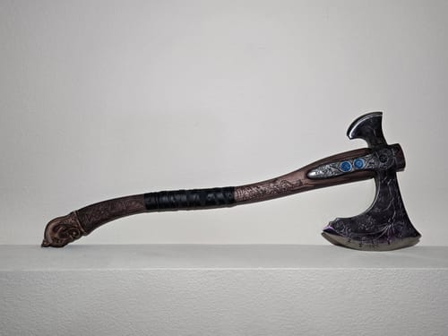 Customer's Ragnarok Kratos axe laid on a white surface, showing the detailed carved handle and axe head.