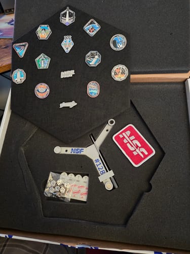 Customer's SpaceX Starship Flight Pin Collection in its packaging, showing the pins, display tile, and serialized mount #128.