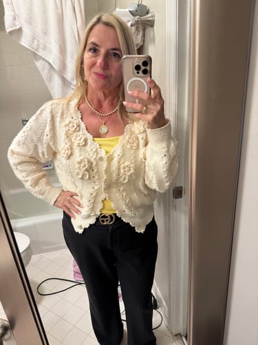 Reviewer wearing the yellow Ribbed Square Neck Tank Top layered under a cream cardigan.