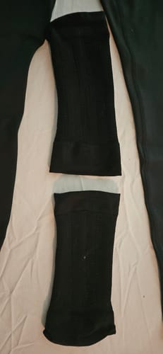 Customer's pair of black Silix™ 3D Compression Sleeves laid out flat on a white surface.