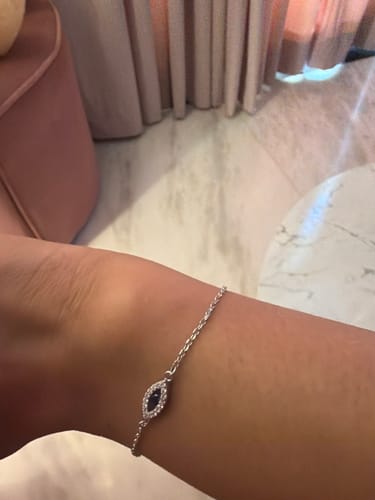 Reviewer wearing the delicate Silver Evil Eye Blue Bracelet on their wrist.