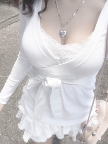 Partial view of a reviewer wearing the cream-white, ruffled Ballerina Bliss Mini Skirt.
