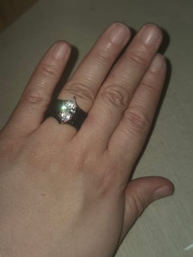 Reviewer's hand wearing the black Silicone Ring Stackable Set with a brilliant marquise-cut stone.