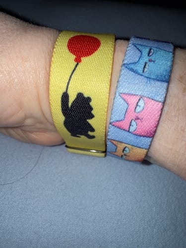 Reviewer's wrist wearing the 'I Do What I Want' Cat Bracelet next to another colorful cat-themed bracelet.