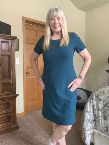 Reviewer wearing the Harlowe Ribbed Dress in Moroccan Blue with hands in the side pockets.