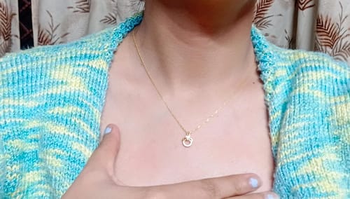 Customer wearing the Golden Adoring Floral Pendant on a delicate link chain.