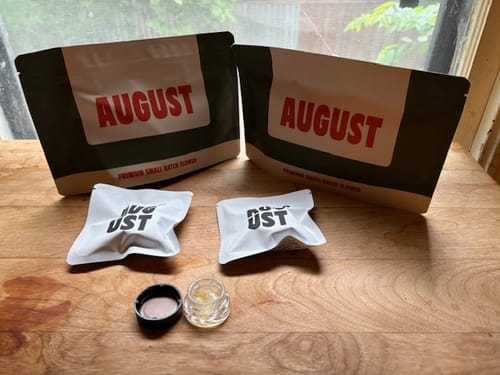 Customer's open jar of THCa Sugar Diamonds on a wooden surface, with branded packaging in the background.