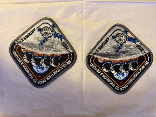 Customer's two embroidered Artemis II - Collectors Patches lying side-by-side on a white surface.
