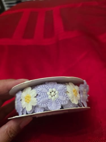Customer holding the large roll of purple and white Retro Flowers Decorative Lace.