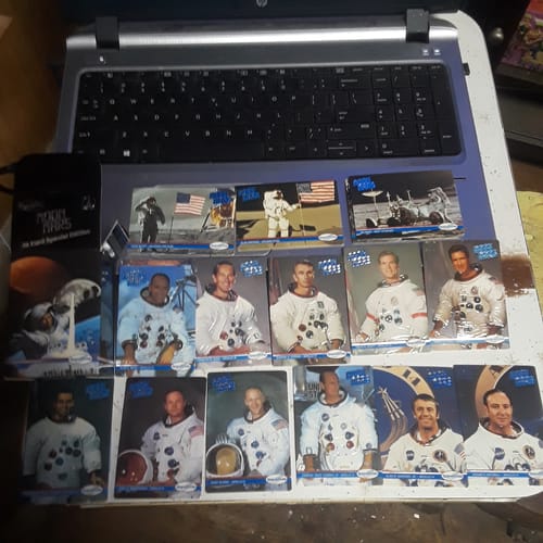 Reviewer's collection of astronaut trading cards laid out on a laptop.