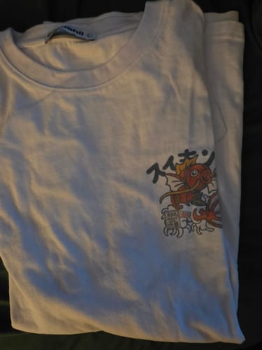 Customer's white Koi King T-Shirt folded to show the colorful koi graphic on the chest.