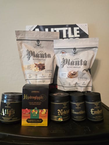 Reviewer's collection of Ambrosia supplements, highlighting two large bags of Planta Premium Plant Protein.