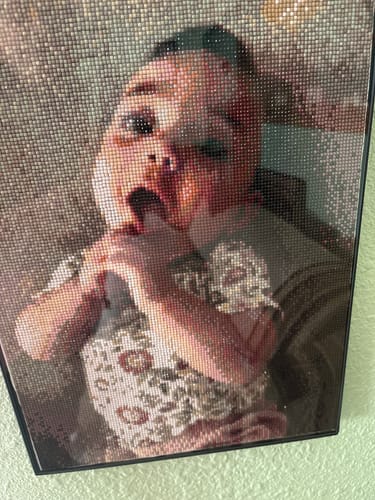 Customer's completed Custom Diamond Painting showing a sparkling portrait of a baby with its mouth open.