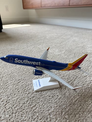 Customer's detailed SKYMARKS SOUTHWEST 737-MAX8 model airplane assembled on its display stand on the floor.