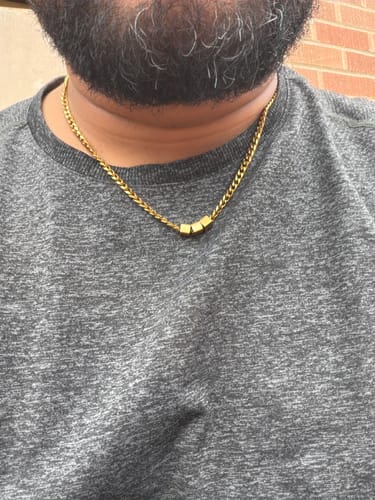 Customer wearing the gold-colored Legacy necklace with three personalized beads.