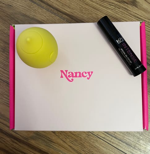 Customer's yellow Lem Clitoral Massager shown on its pink and white packaging box.