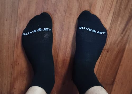 Reviewer wearing the black Quarter Socks, showing the breathable top panel on their feet.
