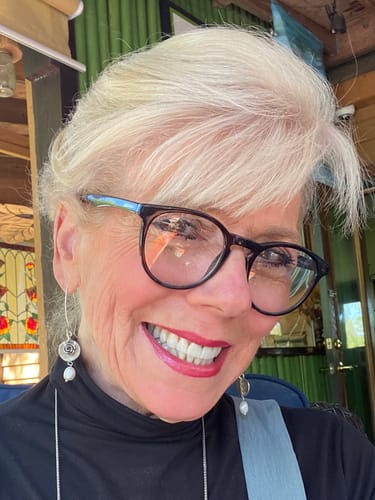 A close-up photo of the smiling reviewer.