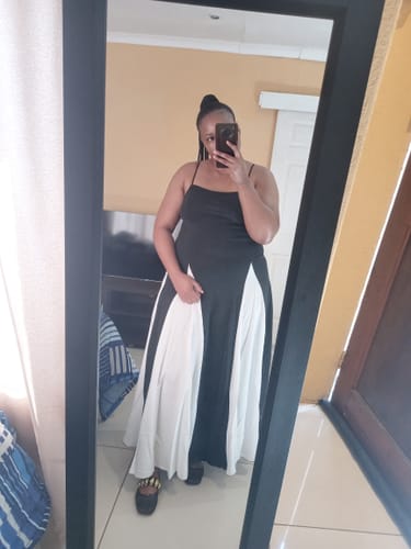 Reviewer in a mirror selfie wearing the Black & White Spaghetti Strap Maxi Dress.