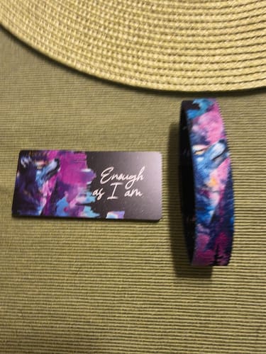 Customer's 'Enough As I am Bracelet' with a vibrant pattern, shown next to its matching collector card.