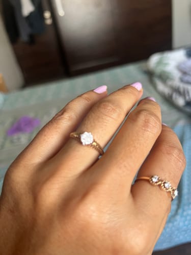 Customer's hand wearing the Gold Modern Matrix Lab Grown Diamond Ring, showing its textured gold band and central diamond.