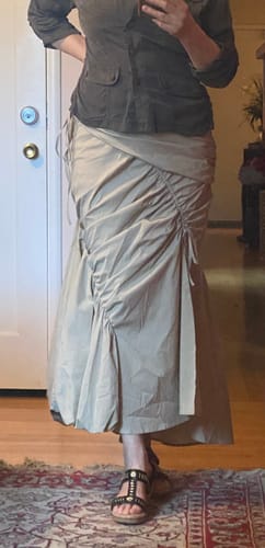 Reviewer wearing the flattering beige Ruffle Midi Fishtail Skirt, showing the ruched side details and overall fit.