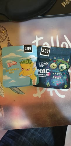 Customer's review showing the packaging for Montgomery Benz THCA Flower, a light blue pouch with cartoon art, next to another product.