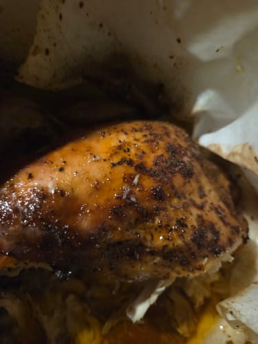 Customer's close-up of their smoked Halal Whole Chicken, showing a golden, seasoned piece.