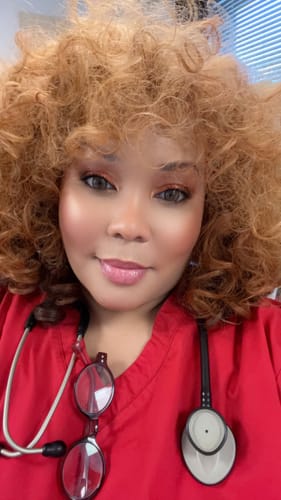 Customer's close-up wearing the Sensationnel GIGI wig, a voluminous unit with light brown curls.
