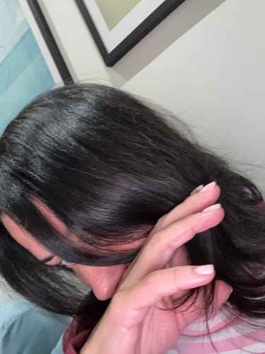 Close-up of a reviewer's shiny, smooth dark hair after using the Ahalo Butter shampoo and treatment.
