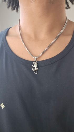 Customer wearing the silver Panther Pendant on a matching chain against a black shirt.
