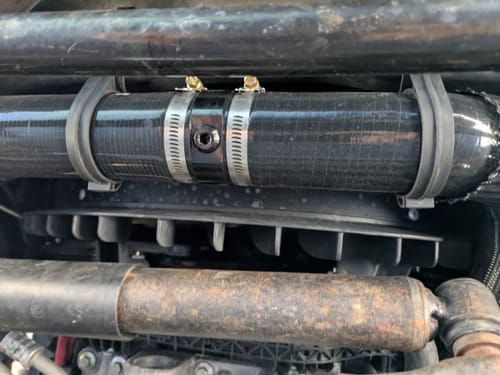 Customer's close-up of the black SPE Motorsport Lower Radiator Hose installed, showing the billet coupler with its drain port.