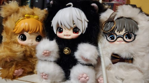 Customer's photo of three fluffy Baby Cat Romantic Escape plush toys in brown, black and white, and all-white.